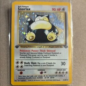 Snorlax 1st edition Pokémon Card with Holographic Design 11/64 NM
